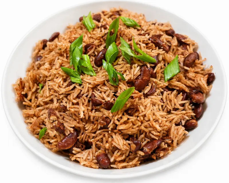 Bowl of Haitian rice and red beans (diri kole) topped with fresh scallions